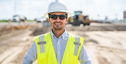 Man on a construction site that uses HCSS software