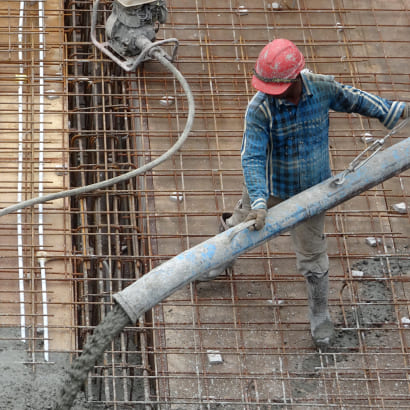 Construction worker pouring concrete