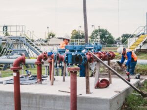 technicians installing pipes water treatment facility