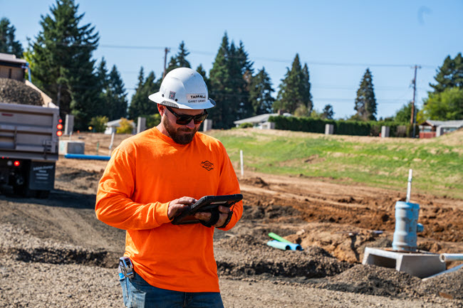 contractor on a tablet in field