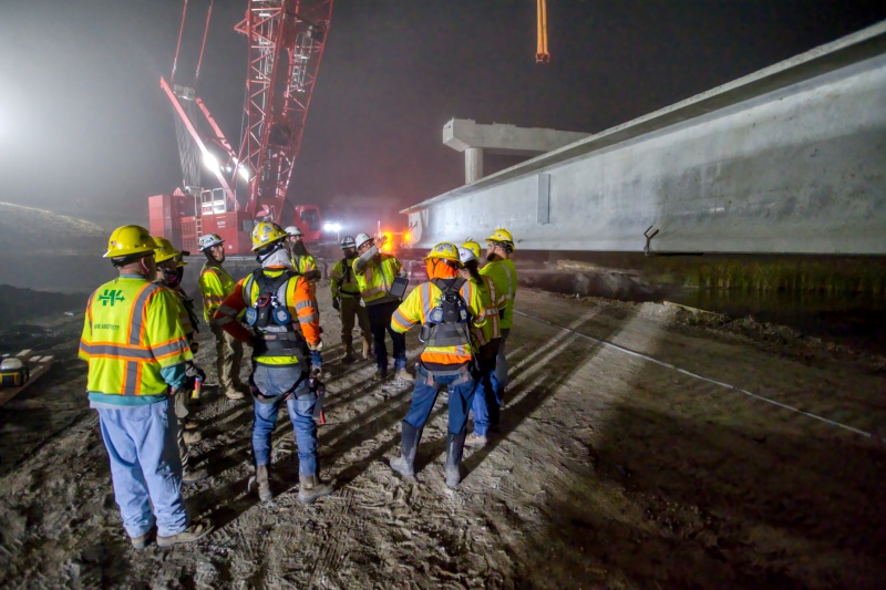 A bridge installation crew at night using HCSS software